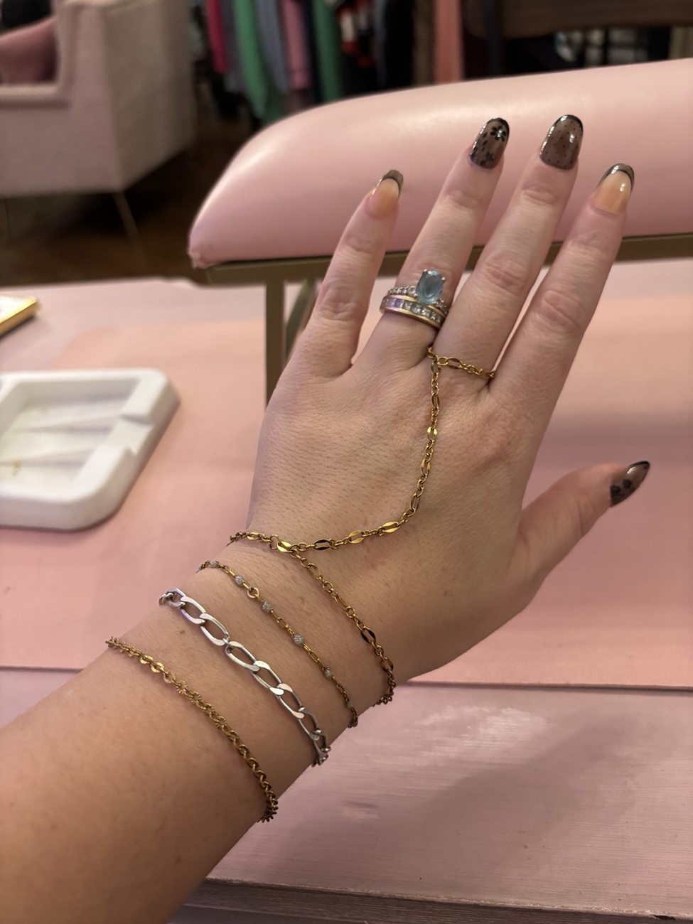 Gold hand chain and stacked bracelets
