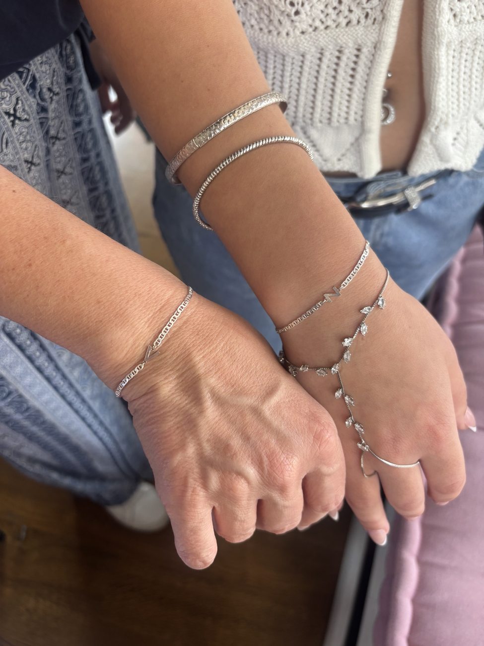 Stacked silver jewelry with a delicate chain